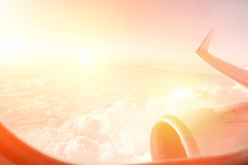 Clouds and sky view from aircraft window at sunset 