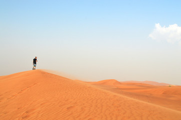 Fototapeta na wymiar man in the setting sun in the desert