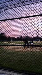 Playing a baseball game at sunset