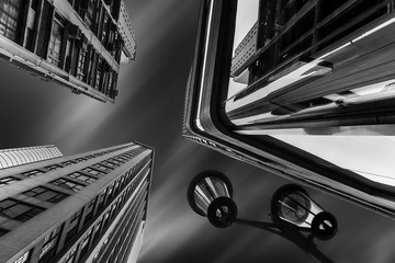 Abstract futuristic cityscape view with modern skyscrapers and street lamp under cloudy night sky. Hong Kong