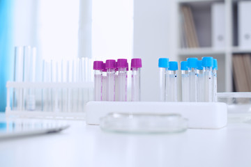 Research laboratory working space. Test tubes and tablet PC are lying at the table. Medical equipment. Blood test