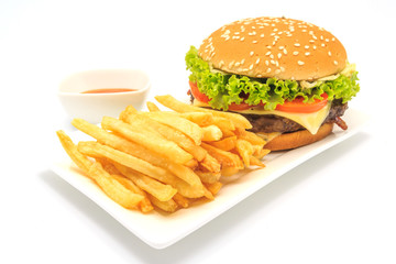 tasty hamburger, French fries and chili sauce on white plate, Fast food with copy space