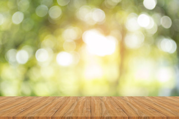 Naklejka na ściany i meble Wood table on shiny sunlight bokeh background.