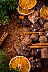 Christmas sweets: assortment of chocolates, truffles, candies, chocolate barks, spices and nuts....