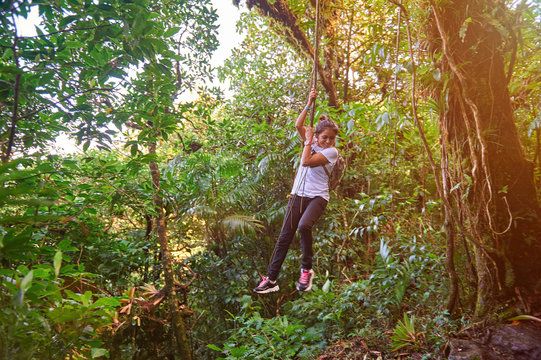 girl hanging on liana