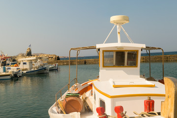 Colorful fish boat against the port of Naoussa at Paros island in Greece.
