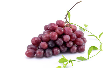 Ripe red grape with leaves isolated on white