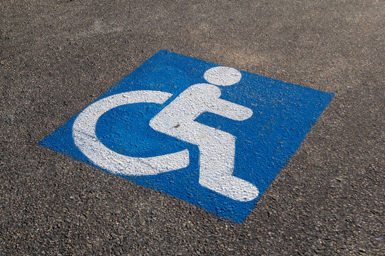 handicapped parking sign paint onto asphalt parking