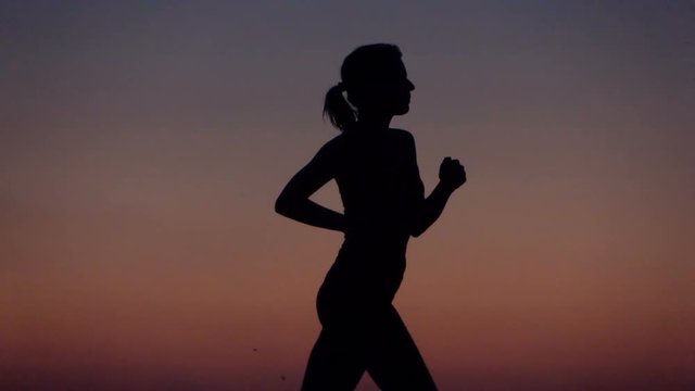 Woman running during sunset in the evening, super slow motion 240fps
