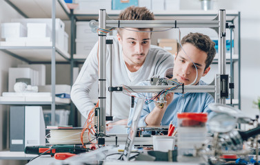 Young researchers and 3D printer © StockPhotoPro