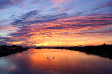Red sky and cloud over the river with boat in Thailand, Ubonratchathani province