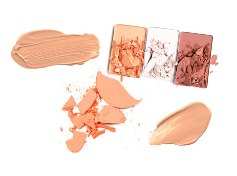 collection of various make up powder samples on white background