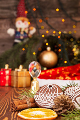 Obraz na płótnie Canvas Christmas gingerbread cookies against background branch of fir t