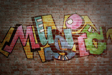 Colorful word MUSIC on brick wall background. Graffiti style