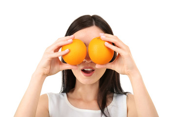 Portrait of young woman with two oranges isolated on white