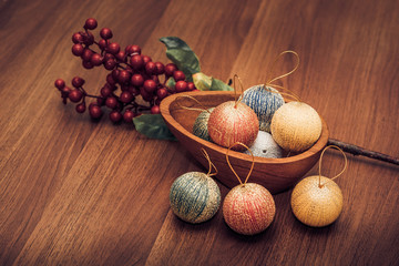 Fototapeta na wymiar Christmas decoration balls with cranberries on wooden table top,