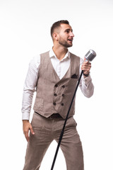 Naklejka premium Young man in suit singing over the microphone with energy. Isolated on white background. Singer concept.