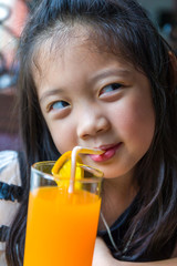 Child Drinking Orange Juice