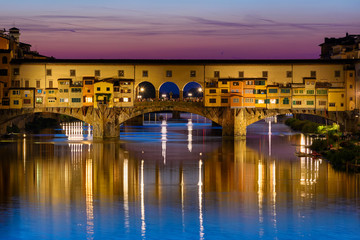 Night view of Ponte Vecchio over Arno River in Florence, Italy