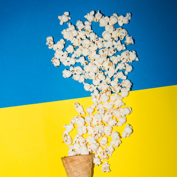 pop corn and ice cream cone, vibrant background, direct flash used