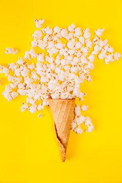 pop corn and ice cream cone, vibrant background, direct flash used