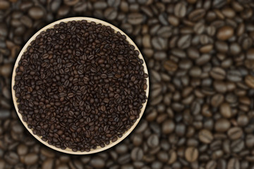 Coffee beans on the plate with coffee beans as a background