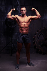 Fototapeta na wymiar Studio photoshooting of bare-chested muscular athlete with healt