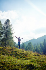  Woman spreading hands and feeling the freedom on the mountain p