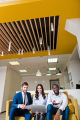 Cheerful colleagues sitting on the couch
