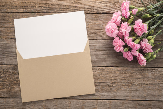   Flowers and envelope on a table