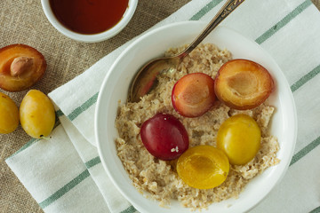 Oatmeal with plums top view