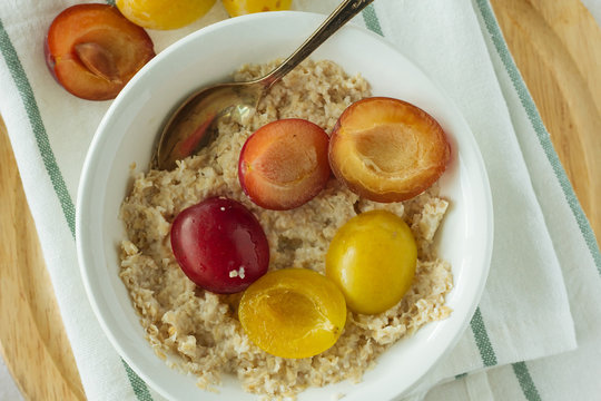 Oatmeal with plums top view