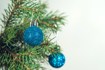 Obraz na płótnie Canvas Christmas baubles on a fir tree branch