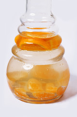 Hookah with a black tube on a white background with fruit on juice