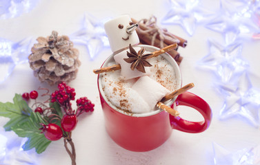 Funny marshmallow snowman in red cup of hot chocolate. Chrismas kids beveradge