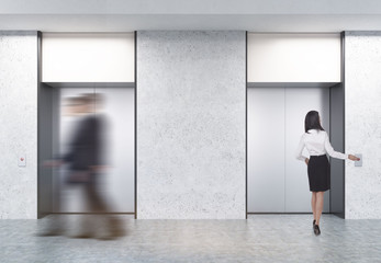 Two men and a woman in elevator hall