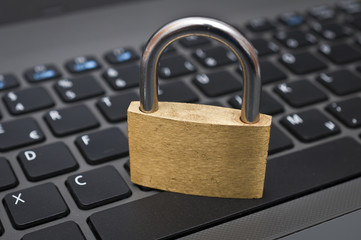 Cyber safety concept - lock on computer keyboard