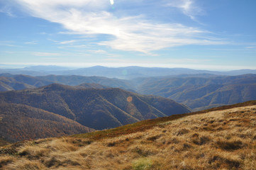 Mountain landscape clouds view with solar lens flare effect