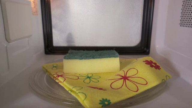 Cleaning kitchen sponge with a microwave oven. Wet the sponge completely and do not allow it to dry