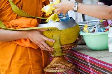 give alms to a Buddhist monk on morning