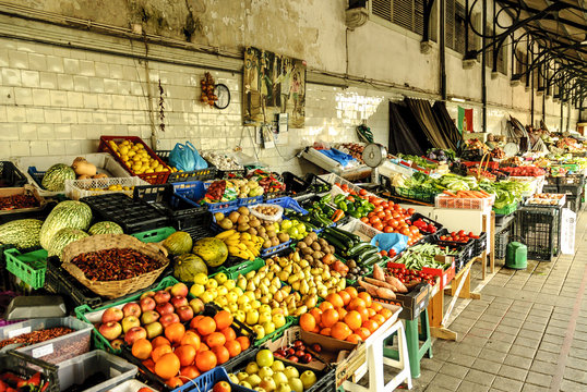 stand of fruits and vegetables inside the historical municipal market of the Bolhao in Oporto, Portugal