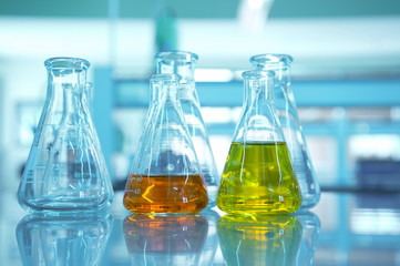 yellow and orange flask in science lab with blue background