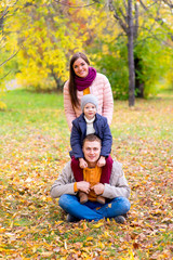Fototapeta premium family pretend pyramid autumn park