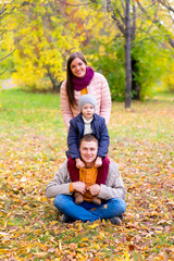 Fototapeta premium family pretend pyramid autumn park