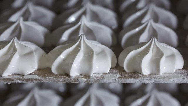 Bakery cooling racks with finished marshmallow zephyr are cooled before packaging at confectionery factory zoom out