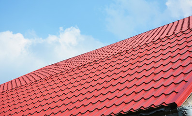 Red metal roof tiles. Metal Roof Shingles - Roofing Construction, Roofing Repair.