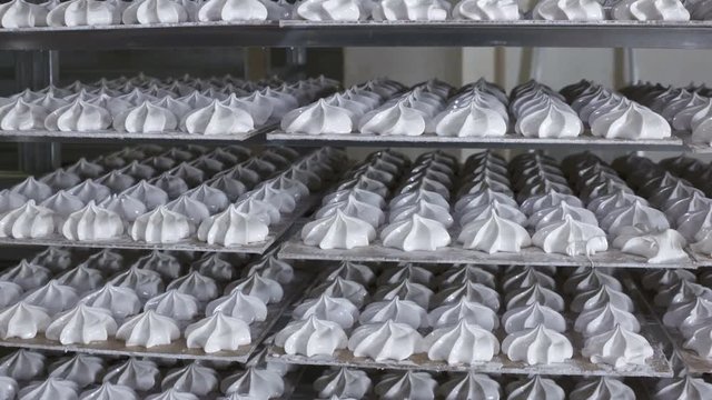 Cooling racks with finished marshmallow zephyr on trays at confectionery factory