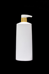 Plastic cosmetic black bottle isolated on black background