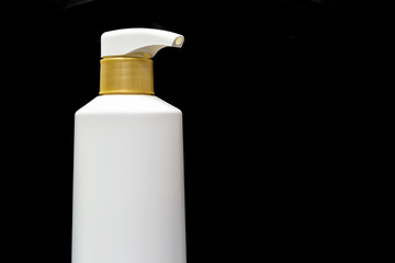 Plastic cosmetic black bottle isolated on black background