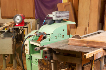 Carpenter tools on wooden table with sawdust. Circular Saw. Carpenter workplace top view
